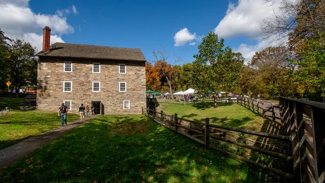 a stone mill with activity and demonstration tents