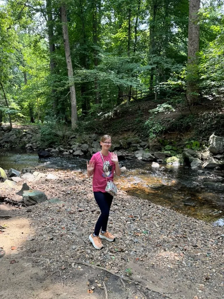 Alina on a creek-side walk in the woods.
