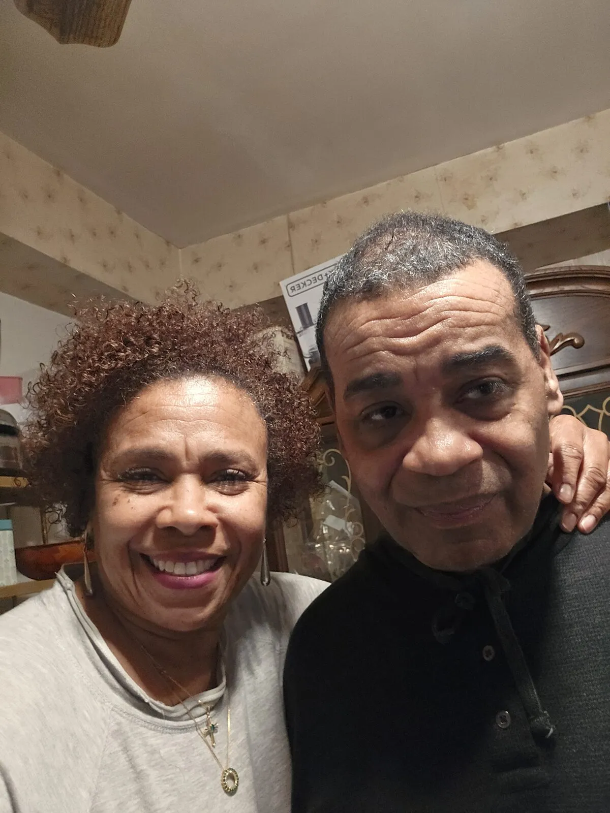 Ms. Richelle and her brother Mr. Rene smile together at home.