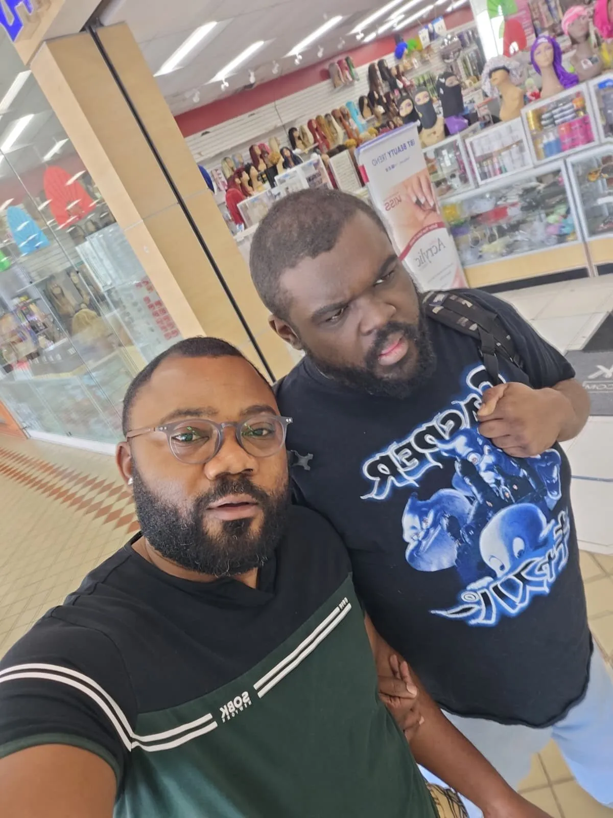Mr. Yannick and Jahvah Jones take a selfie together inside a store.